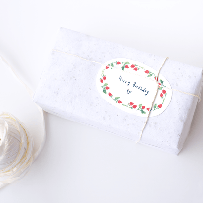 Mini card strawberry oval shape notecard gift card placed on wrapped gift with string