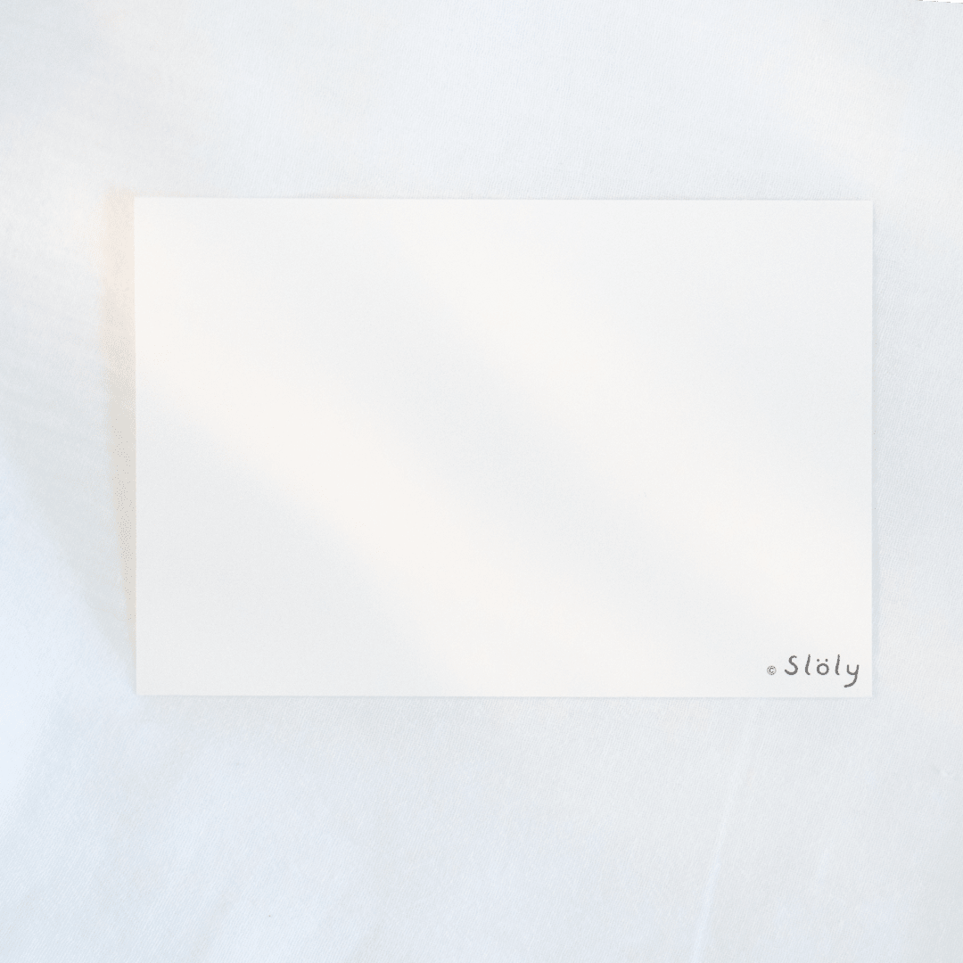 A blank white rectangular card with the small logo “*Söly” in the bottom-right corner, photographed on a soft white textured background.